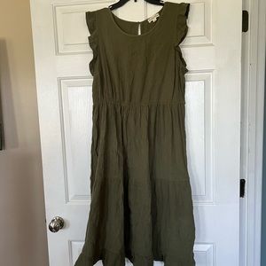 Green tiered skirt dress with ruffled sleeves.